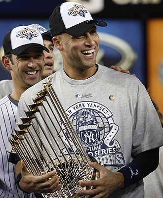 New York Yankees player Jeter celebrates as he holds the World Series trophy after the Yankees defeated the Philadelphia Phillies in New York